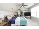 Inviting bedroom featuring a workstation area, ceiling fan, and a large window at 298 Bridges Farm Rd, Mooresville, NC 28115