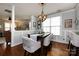 An inviting dining room features a modern light fixture, hardwood floors and an open view to the living room at 298 Bridges Farm Rd, Mooresville, NC 28115