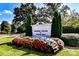 A well-manicured entrance sign for Davidson College with vibrant red and white flowers in front at 298 Bridges Farm Rd, Mooresville, NC 28115