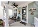 A cozy front porch provides comfortable seating, decorative pillows and a ceiling fan perfect for relaxing outdoors at 298 Bridges Farm Rd, Mooresville, NC 28115