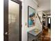 Hallway with pantry and access to other rooms of the home, decorated with art and a small console table at 298 Bridges Farm Rd, Mooresville, NC 28115