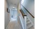 Bright hallway with staircase featuring wooden handrail and carpeted steps at 298 Bridges Farm Rd, Mooresville, NC 28115