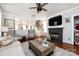 A relaxing living room area features a fireplace, flatscreen TV and an open view to other rooms at 298 Bridges Farm Rd, Mooresville, NC 28115