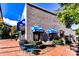 Modern storefront of a Ben & Jerry's ice cream shop, featuring a gray brick exterior and outdoor seating at 298 Bridges Farm Rd, Mooresville, NC 28115