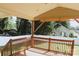 Backyard deck with wooden rails, a roof and a view of the backyard and neighboring houses at 315 Second St, Stanley, NC 28164