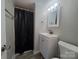Bathroom featuring modern vanity, mirror and shower with black curtain at 315 Second St, Stanley, NC 28164