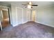A spacious bedroom with carpet flooring, a ceiling fan, and multiple closets for ample storage at 315 Second St, Stanley, NC 28164