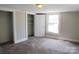 Carpeted bedroom featuring closet and natural light at 315 Second St, Stanley, NC 28164