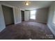 Carpeted bedroom featuring a closet and natural light at 315 Second St, Stanley, NC 28164