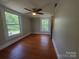 Sunlit bedroom with hardwood floors and ample windows offering scenic views at 315 Second St, Stanley, NC 28164