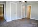 A bedroom featuring carpet flooring, closet space, and a view to the bathroom at 315 Second St, Stanley, NC 28164