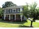 Inviting two-story house featuring a cozy front porch and attractive landscaping at 315 Second St, Stanley, NC 28164