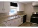 Well-lit kitchen featuring stainless steel appliances, white cabinets, and neutral countertops at 315 Second St, Stanley, NC 28164