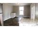 Bright kitchen area features modern countertops, stainless steel refrigerator and dark wood-look flooring at 315 Second St, Stanley, NC 28164