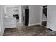 Open kitchen area with stainless steel refrigerator, range, and an open view of the staircase at 315 Second St, Stanley, NC 28164