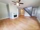 Open living room featuring hardwood floors, a fireplace, and stairs leading to the second floor at 315 Second St, Stanley, NC 28164