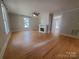 Spacious living room with hardwood floors, a ceiling fan, and a decorative fireplace at 315 Second St, Stanley, NC 28164