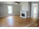 Bright living room with hardwood floors, a ceiling fan, and a decorative fireplace at 315 Second St, Stanley, NC 28164