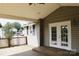 Charming, covered porch with wooden deck and white framed windows at 315 Second St, Stanley, NC 28164