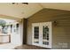 Inviting covered porch with double glass doors leading into the home at 315 Second St, Stanley, NC 28164