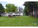 Large backyard features a patio, grill, and mature trees at 318 N Laurel N St, Lincolnton, NC 28092