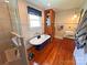 Bright bathroom featuring a glass shower, a standalone tub, and elegant fixtures, alongside a wooden cabinet at 318 N Laurel N St, Lincolnton, NC 28092