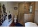 Elegant bathroom featuring a tiled walk-in shower, soaking tub, and wainscoting at 318 N Laurel N St, Lincolnton, NC 28092