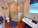 Bright bathroom featuring a glass shower, a standalone tub, and elegant fixtures on a beautiful wood floor at 318 N Laurel N St, Lincolnton, NC 28092