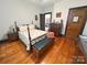 Bedroom with wooden floors, a ceiling fan, neutral walls, and a traditional-style bed with floral bedding at 318 N Laurel N St, Lincolnton, NC 28092