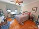 Bright bedroom featuring hardwood floors, a ceiling fan, and ample natural light, creating a cozy and inviting space at 318 N Laurel N St, Lincolnton, NC 28092