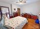 Bedroom with wooden floors, a ceiling fan, neutral walls, and a traditional-style bed with floral bedding at 318 N Laurel N St, Lincolnton, NC 28092
