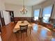 Well-lit dining room featuring a chandelier, hardwood floors and multiple windows with natural light at 318 N Laurel N St, Lincolnton, NC 28092