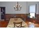 Charming dining room with wood paneling, hardwood floors, and a stylish chandelier at 318 N Laurel N St, Lincolnton, NC 28092