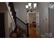 Welcoming foyer with hardwood floors, staircase, and charming chandelier, creating an inviting entrance at 318 N Laurel N St, Lincolnton, NC 28092