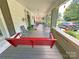 Inviting front porch with a charming red swing and plenty of room for seating at 318 N Laurel N St, Lincolnton, NC 28092