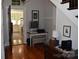 Entry hallway leading to kitchen, featuring hardwood floors, a desk, and natural light at 318 N Laurel N St, Lincolnton, NC 28092