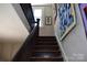 Dark wooden staircase with white walls, accented with art and a bright window at 318 N Laurel N St, Lincolnton, NC 28092