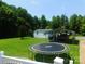 Spacious backyard with a shed, covered parking, green grass and trampoline in a home for sale at 33343 Old Salisbury Rd, Albemarle, NC 28001