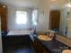 Bathroom features a large soaking tub, vanity and large mirror, bringing brightness to the room at 33343 Old Salisbury Rd, Albemarle, NC 28001