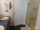 This bathroom has a vanity, toilet and shower with a sliding glass door in a home for sale at 33343 Old Salisbury Rd, Albemarle, NC 28001