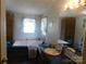 Bathroom with a soaking tub, large mirror, vanity, and traditional-style wallpaper at 33343 Old Salisbury Rd, Albemarle, NC 28001