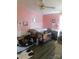 This pink bedroom has a ceiling fan, window, and cribs in a home for sale at 33343 Old Salisbury Rd, Albemarle, NC 28001