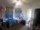 Bedroom with light blue walls, carpet, natural light, and an ensuite bathroom at 33343 Old Salisbury Rd, Albemarle, NC 28001
