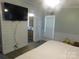 Bedroom view featuring a TV, wood paneling, and access to a bathroom at 33343 Old Salisbury Rd, Albemarle, NC 28001