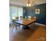 Formal dining room featuring a large wood table, varied chairs, and a dark accent wall at 33343 Old Salisbury Rd, Albemarle, NC 28001