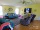 Cozy living room with hardwood floors, a ceiling fan, and comfortable seating at 33343 Old Salisbury Rd, Albemarle, NC 28001