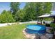 Spacious backyard featuring an above-ground pool, a gazebo, and privacy fence at 389 Whispering Hills Dr, Locust, NC 28097