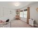 Bright Bedroom with a rocking chair, white crib, natural light, and neutral color palette at 389 Whispering Hills Dr, Locust, NC 28097