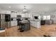 Bright kitchen with stainless steel appliances, granite countertops, and a central island with seating at 389 Whispering Hills Dr, Locust, NC 28097