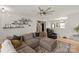 Open concept living room featuring a cozy sectional sofa, wood floors, and modern furnishings at 389 Whispering Hills Dr, Locust, NC 28097